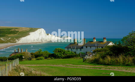 Summer afternoon light on the Severn Sisters white cliffs and the Coast Guard cottages at Cuckmere, in the South Downs National Park, East Sussex, UK Stock Photo