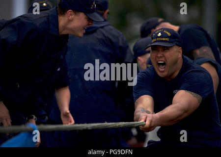 Members of the Coast Guard Cutter Sycamore fight passed the point of exhaustion during the tug-o-war competition as part of the Buoy Tender Olympics at Coast Guard Station Juneau, Alaska, Aug. 22, 2018. The Olympics is a competition that not only builds morale amongst cutter members but also provides a fun alternative to every day training in events such as the chain pull, survival swim and the heat-and-beat. U.S. Coast Guard photo by Petty Officer 1st Class Jon-Paul Rios. Stock Photo