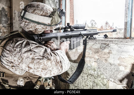 Army sniper shooting with large caliber rifle Stock Photo