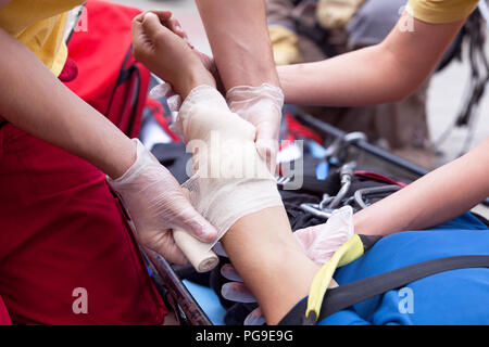 First aid training with demonstration of immobilization and bandaging. First aid after workplace accident Stock Photo