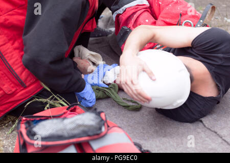 First aid training with simulation of workplace accident and helping  injured worker Stock Photo