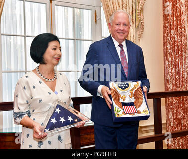 Under Secretary of State for Political Affairs Thomas Shannon, flanked by his wife Guisela Shannon poses for a photo with his awards presented to him during his retirement ceremony at the U.S. Department of State in Washington, D.C., on June 4, 2018. Stock Photo