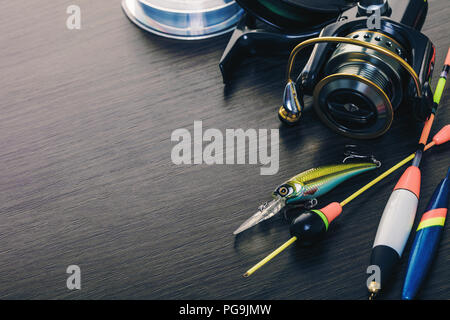 Tackle for fishing rods closeup on wooden background Stock Photo