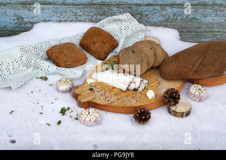 smoked lard with spice and different bread  on the board Stock Photo