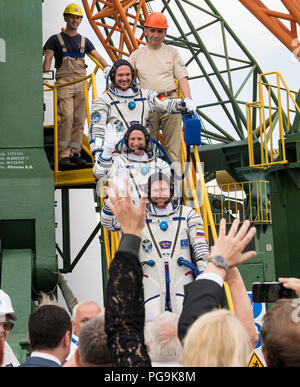 Expedition 56 flight engineer Alexander Gerst of ESA (European Space Agency), top, flight engineer Serena Auñón-Chancellor of NASA, middle, and Soyuz Commander Sergey Prokopyev of Roscosmos, bottom, wave farewell prior to boarding the Soyuz MS-09 spacecraft for launch, Wednesday, June 6, 2018 at the Baikonur Cosmodrome in Kazakhstan. Gerst, Auñón-Chancellor, and Prokopyev will spend the next six months living and working aboard the International Space Station. Stock Photo