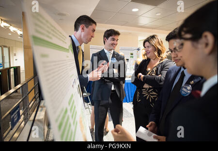 Students and young professionals discuss their projects at the Earth Science Applications Showcase Wednesday, August 1, 2018 at NASA Headquarters in Washington. Every summer, participants in NASA’s Applied Sciences’ DEVELOP National Program come to NASA Headquarters and present their research projects. DEVELOP is a training and development program where students work on Earth science research projects, mentored by science advisers from NASA and partner agencies, and extend research results to local communities. Stock Photo