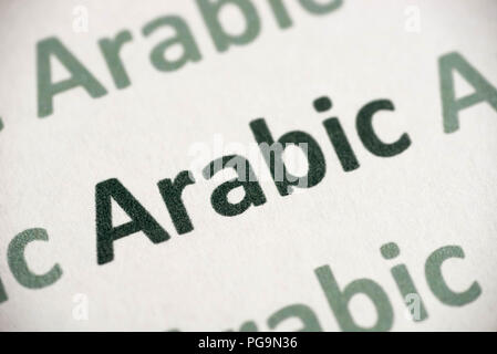 word Arabic language printed on white paper macro Stock Photo