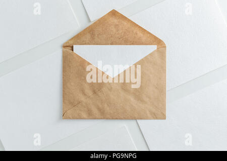 Blank white card in kraft brown envelope and paper cards  template mock up Stock Photo
