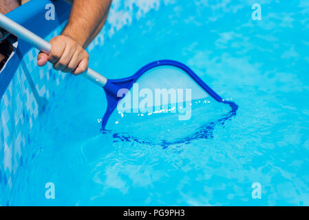 Backyard garden swimming pool cleaning close up Stock Photo