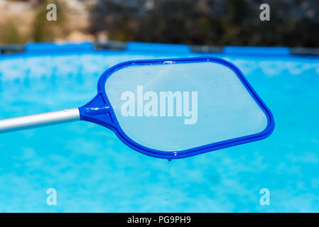 Backyard garden swimming pool cleaning close up Stock Photo