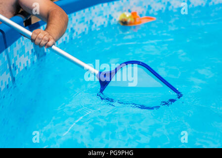Backyard garden swimming pool cleaning close up Stock Photo