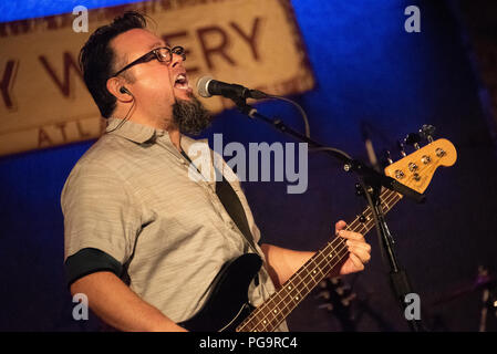 Miguel DeJesus singing and playing electric bass during a Smalltown Poets concert at the City Winery Atlanta. (USA) Stock Photo