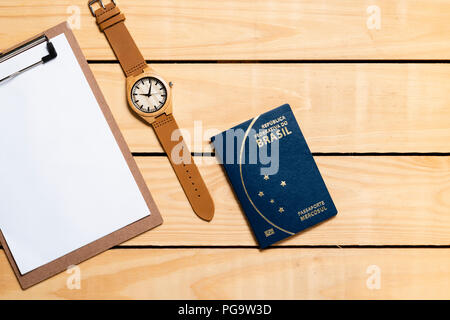 Brazilian Passport on the wooden table and itens for traveling - republica federativa do Brasil, mercosul Stock Photo
