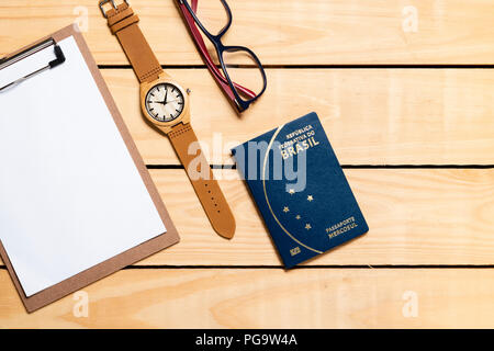 Brazilian Passport on the wooden table and itens for traveling - republica federativa do Brasil, mercosul Stock Photo