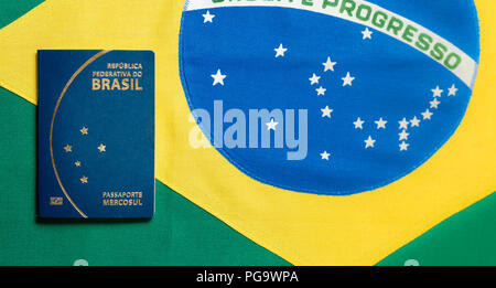 Brazilian Passport on Brazilian flag background - republica federativa do Brasil, mercosul Stock Photo