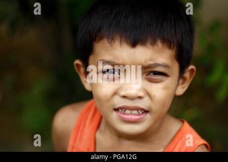 ANTIPOLO CITY, PHILIPPINES - AUGUST 18, 2018: A young Asian boy poses and smiles for the camera. Stock Photo