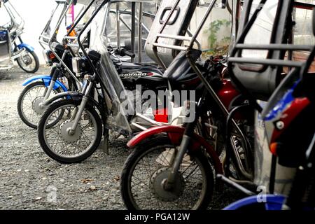 Antipolo City, Philippines - August 18, 2018: Tricycles at a parking lot waiting in line for their turn to take passengers. Stock Photo