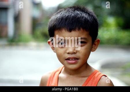 ANTIPOLO CITY, PHILIPPINES - AUGUST 18, 2018: A young Asian boy poses and smiles for the camera. Stock Photo