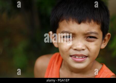 ANTIPOLO CITY, PHILIPPINES - AUGUST 18, 2018: A young Asian boy poses and smiles for the camera. Stock Photo