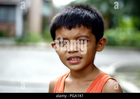 ANTIPOLO CITY, PHILIPPINES - AUGUST 18, 2018: A young Asian boy poses and smiles for the camera. Stock Photo