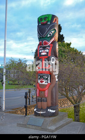 The Kwakiutl Bear Totem Pole by Henry Hunt in the Inner Harbour in downtown Victoria BC Stock Photo