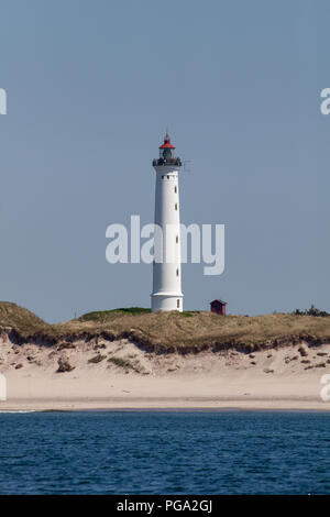 People standing on top of Lyngvig Lighthouse (Lyngvig Fyr) on the west coast of Jutland coast in Denmark. The lighthouse was built in 1906 and was the last built along this coast. Although no longer used for maritime navigation, it was built following a tragic accident at sea in 1903, where 24 sailors lost their lives. The light was lit for the first time on 3rd November 1906. Stock Photo