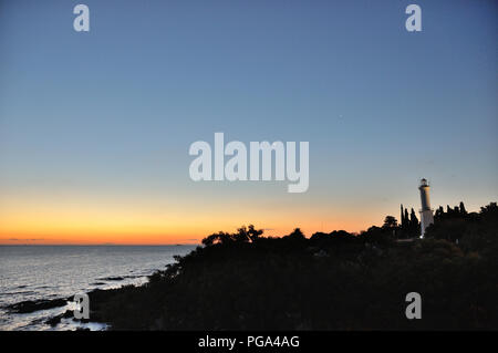 sunset in Colonia del Sacramento, Uruguay, with lighthouse above Rio de la Plata Stock Photo