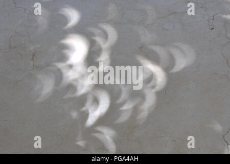 reflection of solar eclipse displayed on marble floor Stock Photo