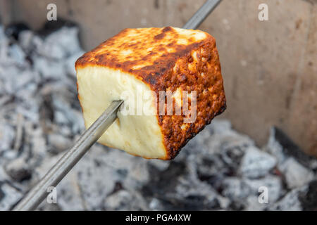 Traditional brazilian Coalho cheese backed on the charcoal. Stock Photo