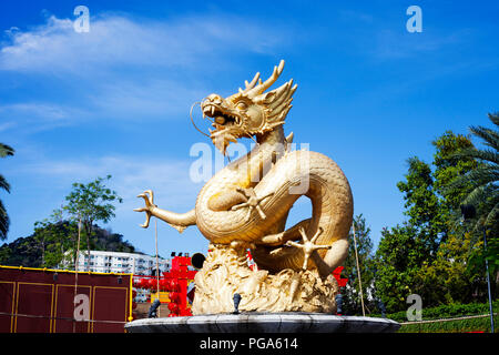 Fountain with gold Dragon in Phuket Town, Thailand. Golden chinese Sea Dragon  sculpture, Hai Leng Ong Statue at Queen Sirikit Park