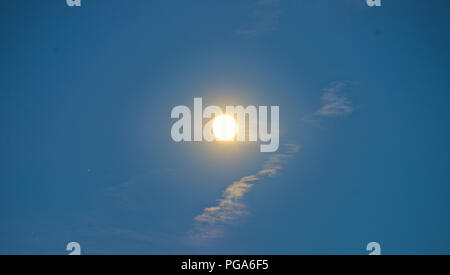 Full moon during sunset on blue sky Stock Photo