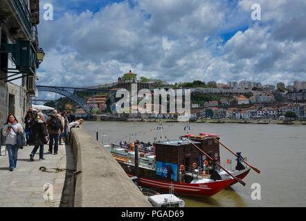 Tourists and locals in the heart of beautiful Porto, the famous bridge 'Ponte Dom Luis I' in the background. Stock Photo