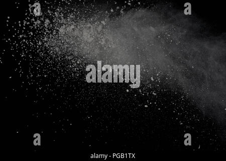White powder explosion isolated on black background. Colored dust splatted. Stock Photo