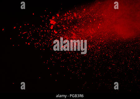 Abstract of red powder explosion on black background. Red powder splatted isolate. Colored cloud. Colored dust explode. Paint Holi. Stock Photo