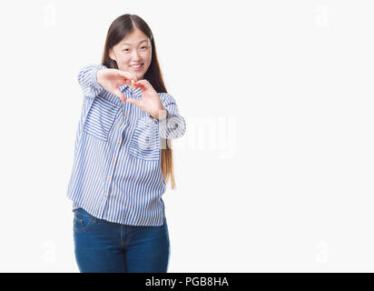 Young Chinese woman over isolated background smiling in love showing heart symbol and shape with hands. Romantic concept. Stock Photo