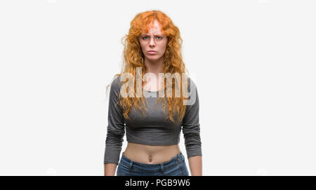 Young redhead woman skeptic and nervous, frowning upset because of problem. Negative person. Stock Photo