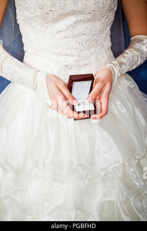 Bride looks at box with engagement ring Stock Photo