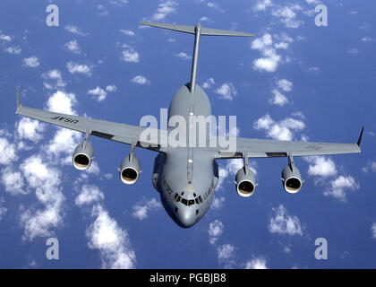 A C-17 Globemaster III aircraft from the 7th Air Lift Sqadron, 62nd Air Lift Wing, McChord Air Force Base, Washington, seperates from a KC-135R (not shown) from the 909th Air Refueling Squadron, 18th Wing, Kadena Air Base, Japan, during a refueling mission over the South China Sea in support of an India earthquake support mission, the Globemaster aircraft was carrying 13,000lbs of tents and blankets. Stock Photo