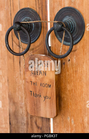 Wooden plate with sign Please clean the room on vintage door Stock Photo