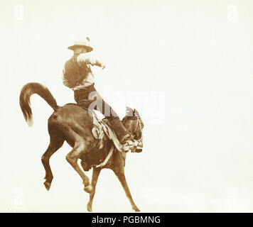 Cowboy on a bucking Bronco 1880s Stock Photo