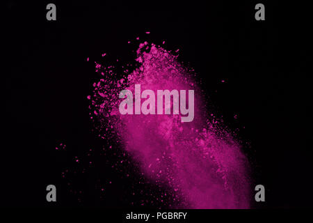 Abstract pink powder explosion on black background. abstract colored powder splatted, Freeze motion of pink powder exploding. Stock Photo