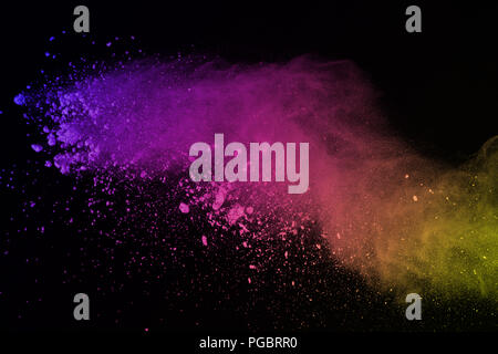 Freeze motion of colored powder explosion isolated on black background. Abstract of colorful dust splatted.
