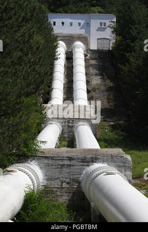 Pipes of a hydroelectric power station in nature. Lake Iskar hydroelectric dam. Kokalyane Hydroelectric Power Plant in Pancharevo, Sofia. Tubes Stock Photo