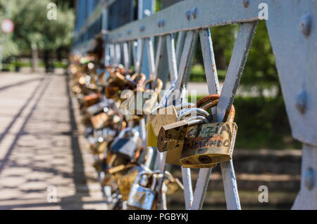 CLUJ-NAPOCA, ROMANIA - JULY 29, 2018: old love padlocks on  Elizabeta Bridge railing  on Somes River in Cluj, Transylvania Stock Photo