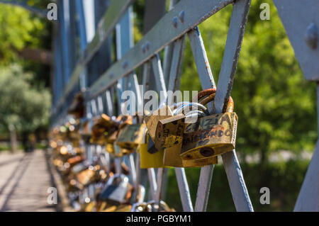CLUJ-NAPOCA, ROMANIA - JULY 29, 2018: old love padlocks on  Elizabeta Bridge railing  on Somes River in Cluj, Transylvania Stock Photo