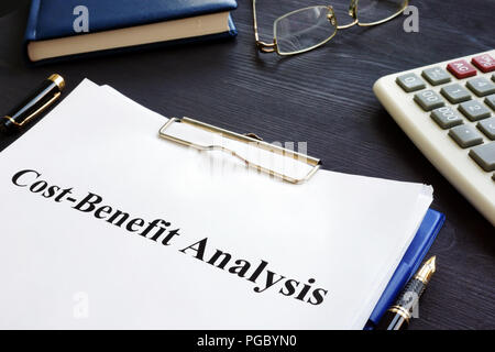 Cost Benefit Analysis CBA and pen on a desk. Stock Photo