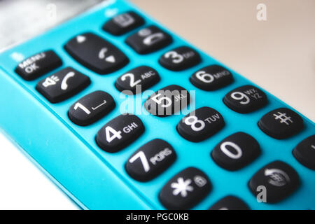 Closeup on keypad of a blue hand-held phone Stock Photo