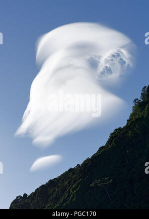 In front of a steep wall, a cloud forms with a special shape reminiscent of a ghost - Location: Azores, Sao Jorge Island Stock Photo