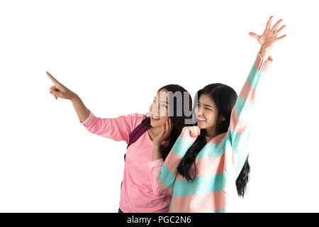Two cute asian girls in happy movement on white background. Stock Photo