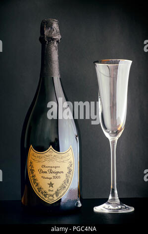 Tambov, Russian Federation - August 14, 2018 Bottle of Champagne Dom Perignon Vintage 2005 with wineglass against black background. Studio shot. Stock Photo